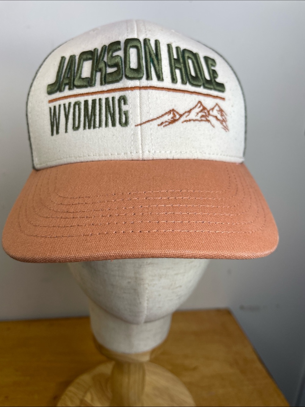 Legacy Jackson Hole Wyoming Trucker Hat in Cream and Coral-Tan